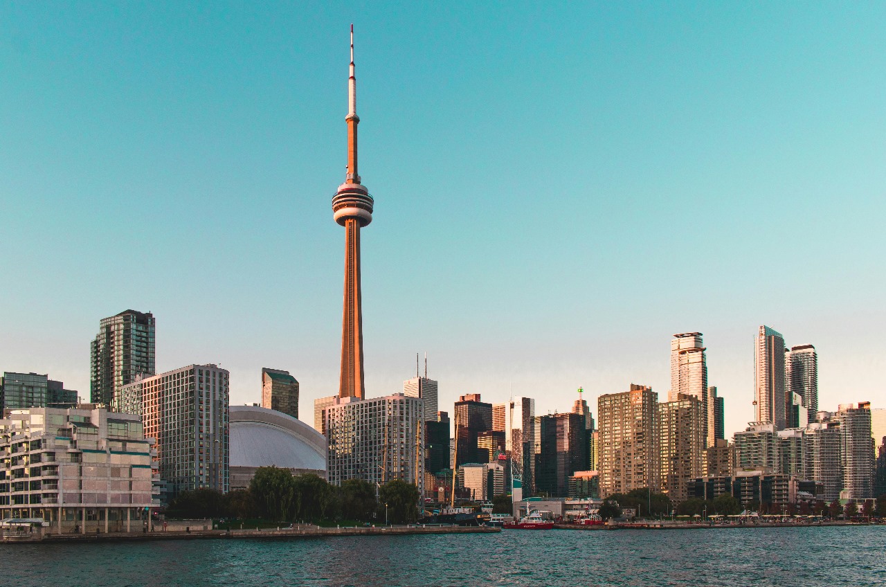 Toronto's CN Tower and modern skyline from across the water, showcasing Canada's vibrant cities and excellent educational institutions