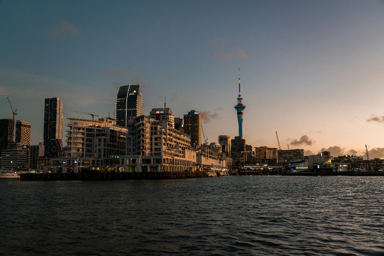 Auckland's waterfront and Sky Tower at sunset, showcasing New Zealand's modern cities and stunning natural beauty with quality education opportunities