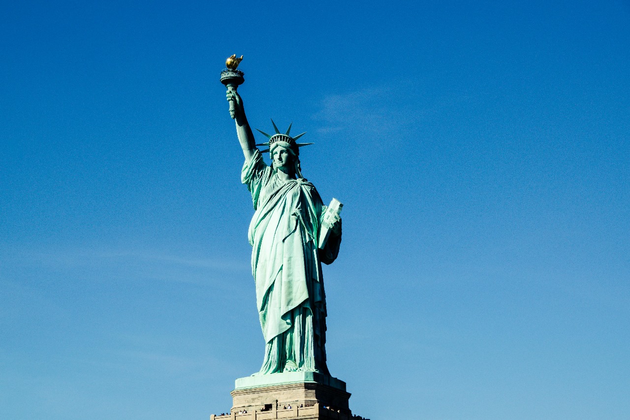 Iconic Statue of Liberty against clear blue sky, representing America's symbol of freedom and opportunity for international education